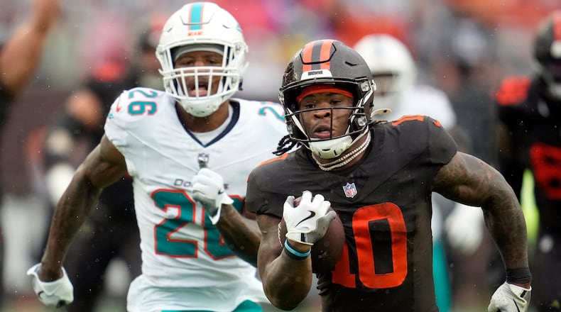 Cleveland Browns running back Quinshon Judkins (10) carries the ball ahead of Miami Dolphins cornerback Rasul Douglas (26) in the first half of an NFL football game in Cleveland, Sunday, Oct. 19, 2025. (AP Photo/Sue Ogrocki)