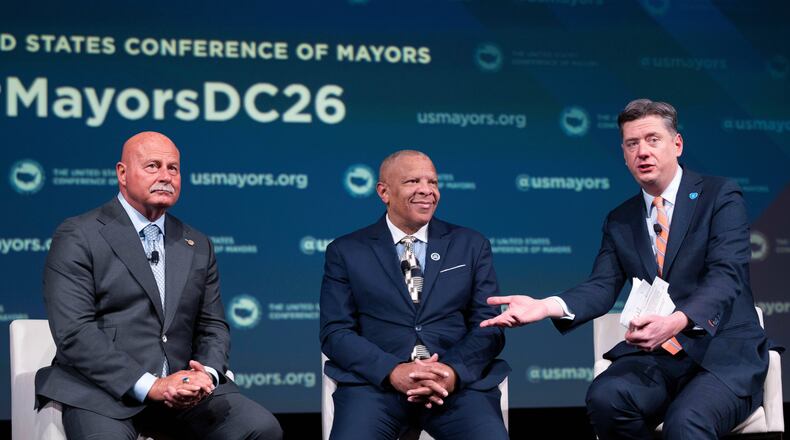 Oklahoma City Mayor David Holt, right, speaks during a panel discussion with Fresno, Calif. Mayor Jerry Dyer, left, and Omaha, Neb. Mayor John Ewing, Jr. during the 94th Winter Meeting of the U.S. Conference of Mayors, Wednesday, Jan. 28, 2026 in Washington. (AP Photo/Kevin Wolf)