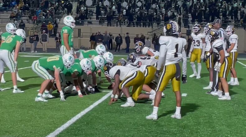 Buford quarterback Ashton Daniels (12) brings his team to the line for the final snap of the Wolves' 21-6 victory over Carrollton in the Class 6A semifinals on Dec. 3, 2021.