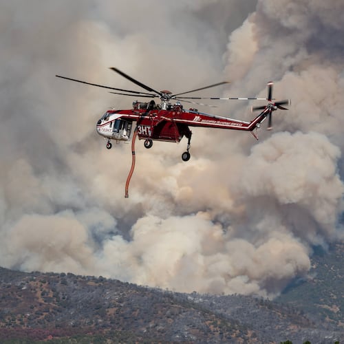 A Sikorsky Skycrane maneuvers into position to refill during efforts to fight the Widemouth 2 Fire east of Fillmore, Utah, on Tuesday, Aug. 4, 2026, before it crashed on Friday, Aug. 7. (Scott G Winterton/The Deseret News via AP)