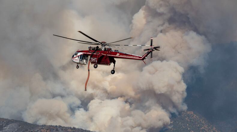 A Sikorsky Skycrane maneuvers into position to refill during efforts to fight the Widemouth 2 Fire east of Fillmore, Utah, on Tuesday, Aug. 4, 2026, before it crashed on Friday, Aug. 7. (Scott G Winterton/The Deseret News via AP)