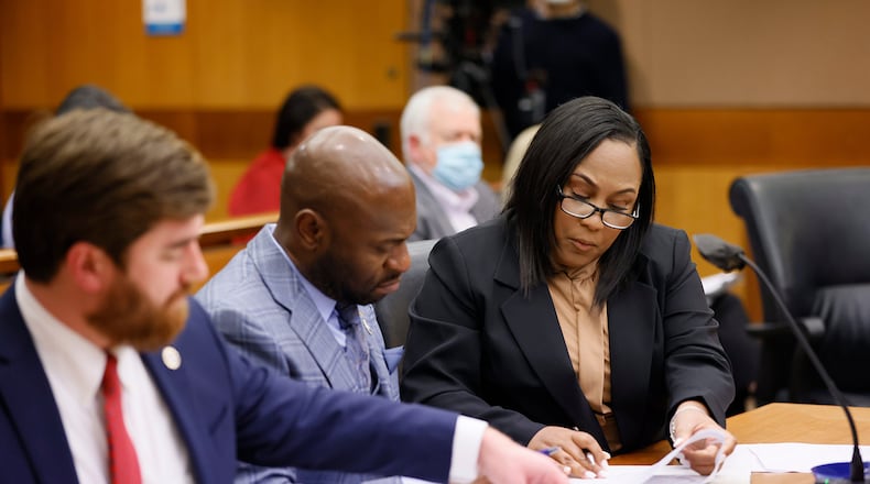 Fulton County District Attorney Fani Willis (right) interacts with colleagues Donald Wakeford (left) and Nathan Wade (center) during a hearing on Jan. 24, 2023. (Miguel Martinez/Atlanta Journal-Constitution/TNS)