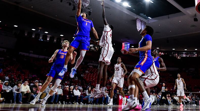 Florida guard Xaivian Lee (1) shoots against Oklahoma forward Kuol Atak (22) during the first half of an NCAA college basketball game, Tuesday, Jan. 13, 2026, in Norman, Okla. (AP Photo/Gerald Leong)