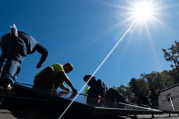 Workers install solar panels on Nathan Shaffer’s roof in Decatur. Though domestic manufacturing is growing, businesses have for years relied heavily on imported panels. (Ben Gray for the AJC)