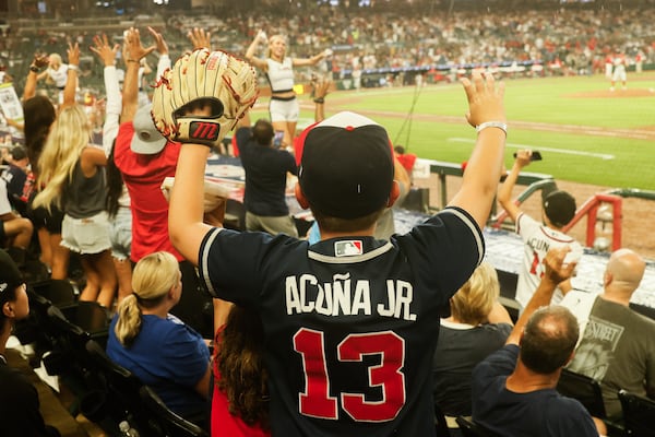 A Braves fan hopes for a giveaway during a June game at Truist Park.