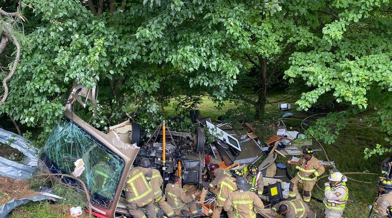 Crews worked for about an hour to rescue a man and a woman trapped inside an overturned RV on the side of I-20, according to an Atlanta fire official.