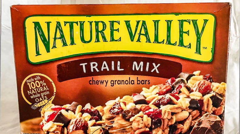 Nature Valley granola bars will lose the 100 percent natural label after parent company General Mills settled a recent lawsuit after it was found that the oats used contained a small amount of a cancer-linked pesticide.