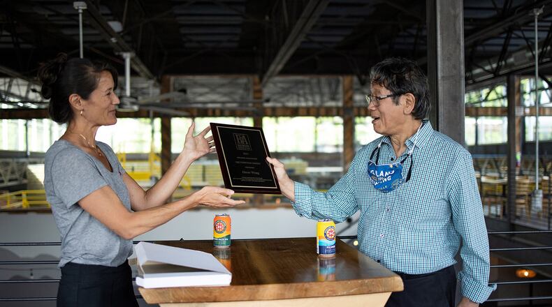 Oscar Wong, founder of Highland Brewing Co., receives the Brewers Association Recognition Award from his daughter, Leah Wong Ashburn. CONTRIBUTED BY HIGHLAND BREWING CO.