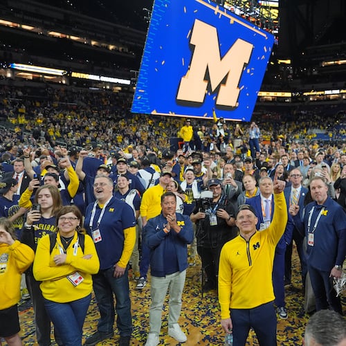Michigan head coach Dusty May celebrates after defeating UConn in the NCAA college basketball tournament national championship game at the Final Four, Tuesday, April 7, 2026, in Indianapolis. (AP Photo/Michael Conroy)