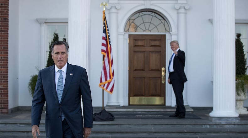 BEDMINSTER TOWNSHIP, NJ - NOVEMBER 19: (L to R) Mitt Romney walks to speak to the press as President-elect Donald Trump gives the thumbs up after their meeting at Trump International Golf Club, November 19, 2016 in Bedminster Township, New Jersey. Trump and his transition team are in the process of filling cabinet and other high level positions for the new administration. (Photo by Drew Angerer/Getty Images) *** BESTPIX ***