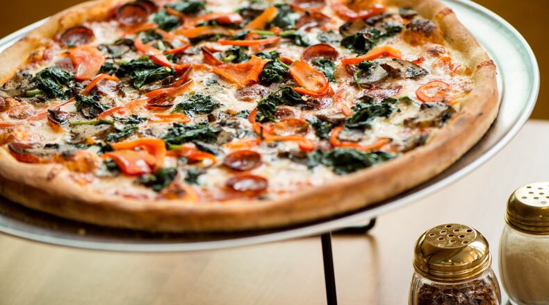 A 16-inch Junior’s Pizza pie with pepperoni, red bell peppers, mushrooms and spinach. CONTRIBUTED BY MIA YAKEL
