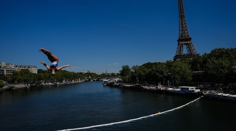 France's Madeleine Bayon competes during round 1 of the Women's 20m Platform as the Eiffel Tower is seen in the background at the European Aquatics Championships in Paris, Friday, Aug. 7, 2026. (AP Photo/Aurelien Morissard)