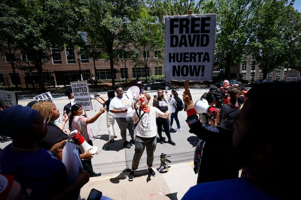 Atlanta's Elias Nail-DuPree (center) speaks during a rally Monday against the arrest of SEIU California leader David Huerta in Los Angeles and the nationwide ICE arrests. The rally was outside the Immigration and Customs Enforcement building in Atlanta. (Miguel Martinez/AJC)