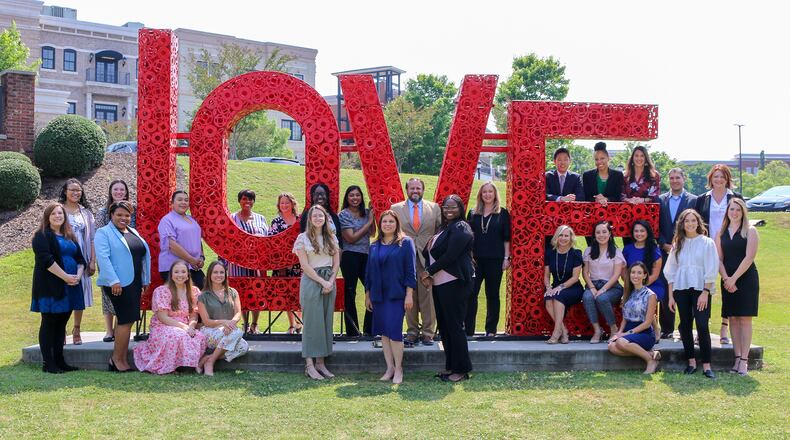 Gwinnett Chamber staff pose in front of the "LOVE" mural in downtown Suwanee
