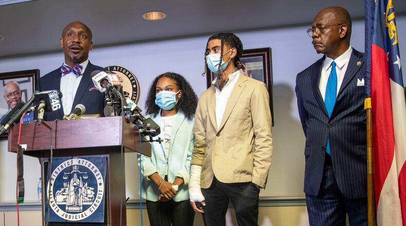 Attorney Mawuli Mel Davis (left) speaks on behalf of Taniyah Pilgrim (second from left) and Messiah Young (second from right)during a press conference by the Fulton County District Attorney's Office in Atlanta, Monday, June 2, 2020. District Attorney Paul Howard and members of the Fulton County District Attorney's Office are pressing charges against 6 Atlanta Police Officers for their involvement in the assault and property damage to Taniyah Pilgrim and Messiah Young.  Attorney Mawuli Mel Davis is representing Messiah Young. (ALYSSA POINTER / ALYSSA.POINTER@AJC.COM)