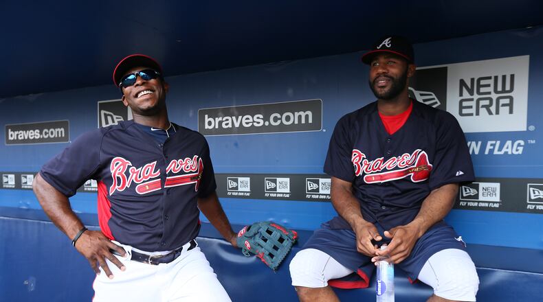 Heyward (right) is still able to manage a little smile as Justin Upton (left) welcomes him back in the dugout. Hayward didn’t have to have his jaw wired shut. It is stabilized with rubber bands that are attached to braces on his teeth.
