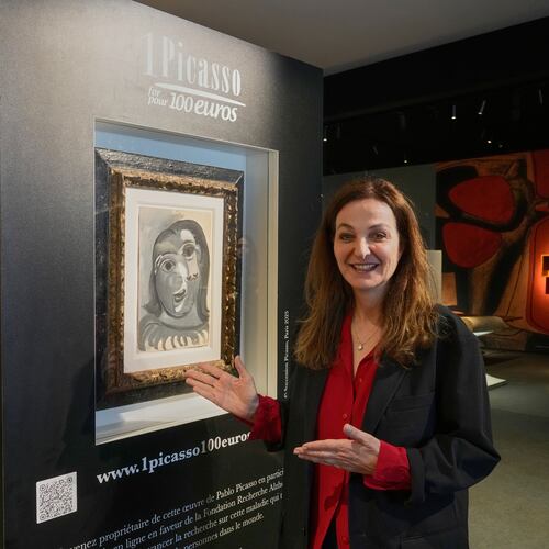 Peri Cochin, co-founder of the "1 Picasso for 100 euros" poses next to Head of a Woman by Pablo Picasso, painted in 1941, in Paris, Friday, April 10, 2026, ahead of a lottery in which the painting is being raffled off to raise money for Alzheimer’s research. (AP Photo/Michel Euler)