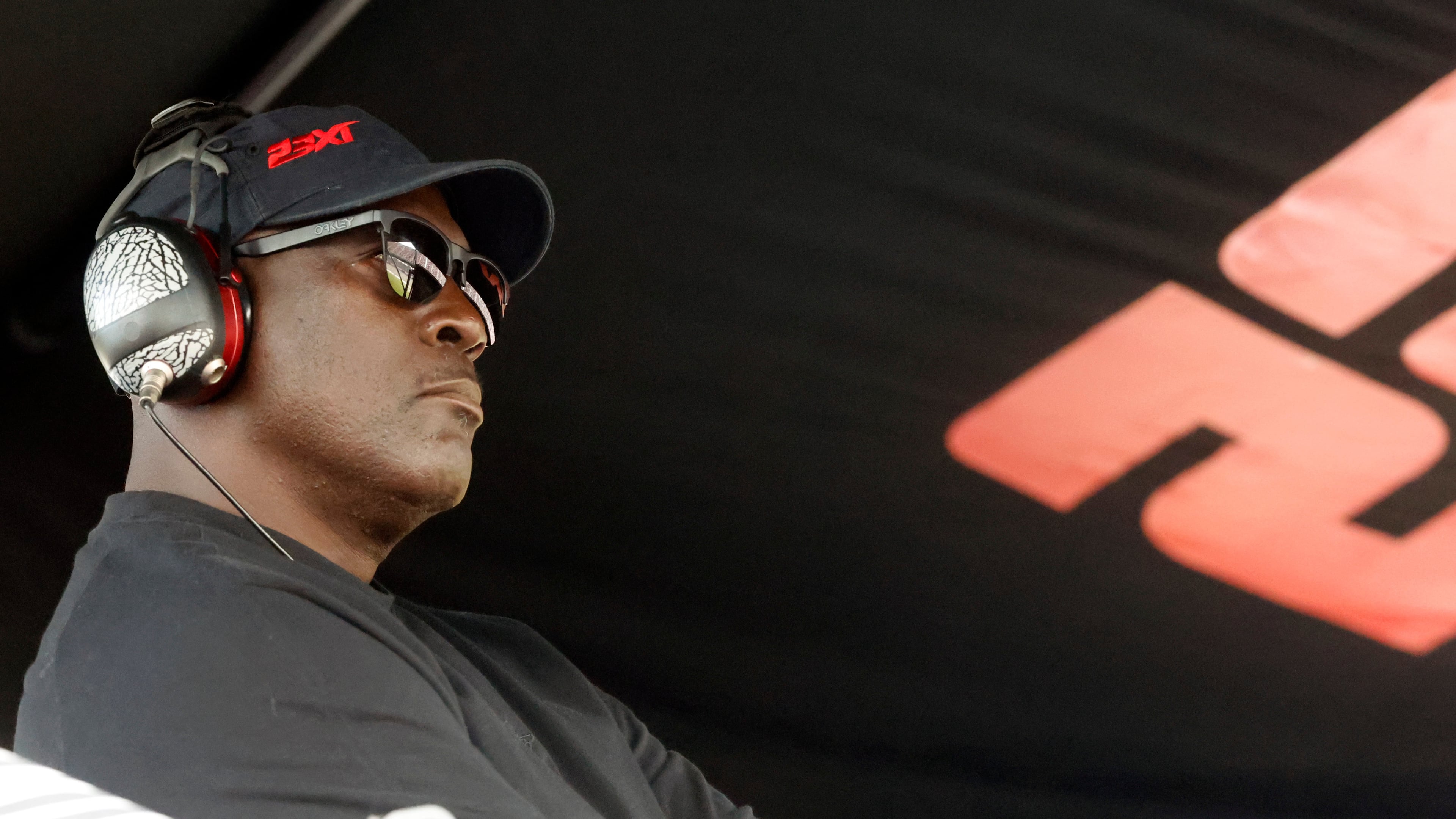 FILE - Michael Jordan, co-owner of 23XI Racing, sits in his pit box during a NASCAR Cup Series auto race at Talladega Superspeedway, Sunday, Oct. 6, 2024, in Talladega, Ala. (AP Photo/ Butch Dill, File)