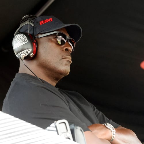 FILE - Michael Jordan, co-owner of 23XI Racing, sits in his pit box during a NASCAR Cup Series auto race at Talladega Superspeedway, Sunday, Oct. 6, 2024, in Talladega, Ala. (AP Photo/ Butch Dill, File)