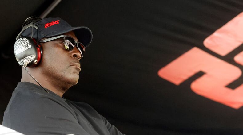 FILE - Michael Jordan, co-owner of 23XI Racing, sits in his pit box during a NASCAR Cup Series auto race at Talladega Superspeedway, Sunday, Oct. 6, 2024, in Talladega, Ala. (AP Photo/ Butch Dill, File)
