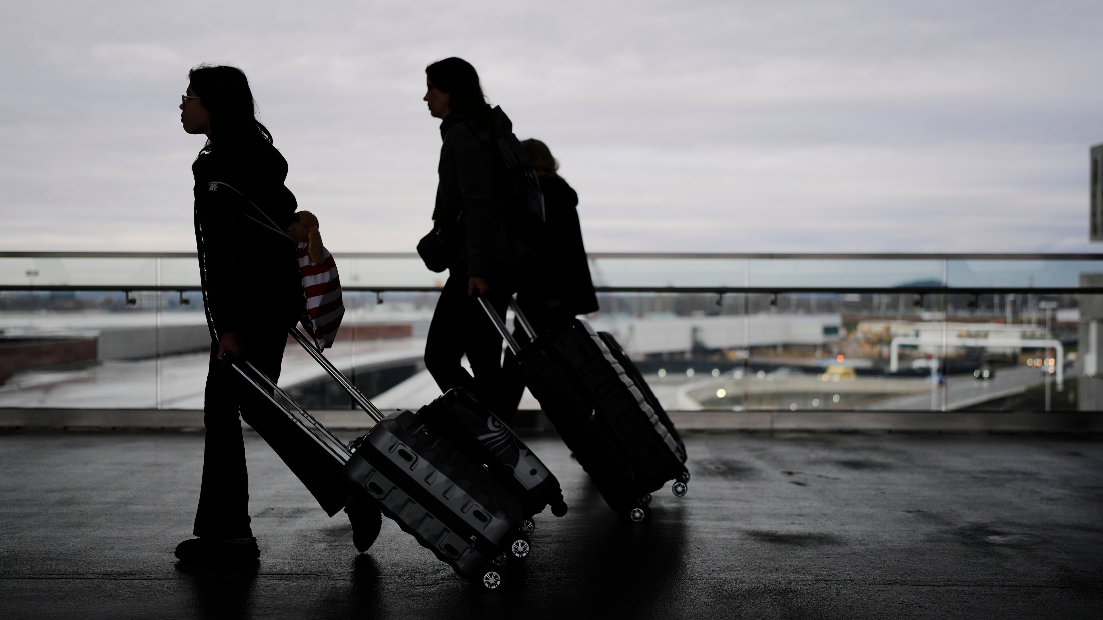 Travelers make their way through the Nashville International Airport, Tuesday, Nov. 25, 2025, in Nashville, Tenn. (AP Photo/George Walker IV)