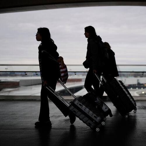 Travelers make their way through the Nashville International Airport, Tuesday, Nov. 25, 2025, in Nashville, Tenn. (AP Photo/George Walker IV)