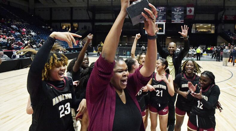Brookwood's head coach Courtney Mincy holds up the championship trophy during 2023 GHSA Basketball Class 7A Girl’s State Championship game at the Macon Centreplex, Saturday, March 11, 2023, in Macon, GA. (Hyosub Shin / Hyosub.Shin@ajc.com)