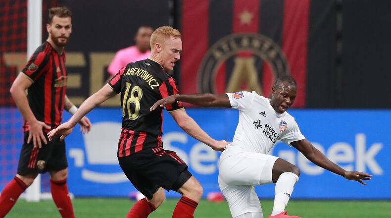 Atlanta United midfielder Jeff Larentowicz knocks FC Cincinnati forward Kekuta Manneh to the turf during the first half in their MLS soccer match on Sunday, March 10, 2019, in Atlanta.    Curtis Compton/ccompton@ajc.com