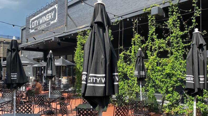 The May reopening of City Winery brought a revamped design with plenty of outdoor upgrades that include umbrella tables and plush lounge seating around a fire pit. (Ligaya Figueras / ligaya.figueras@ajc.com)