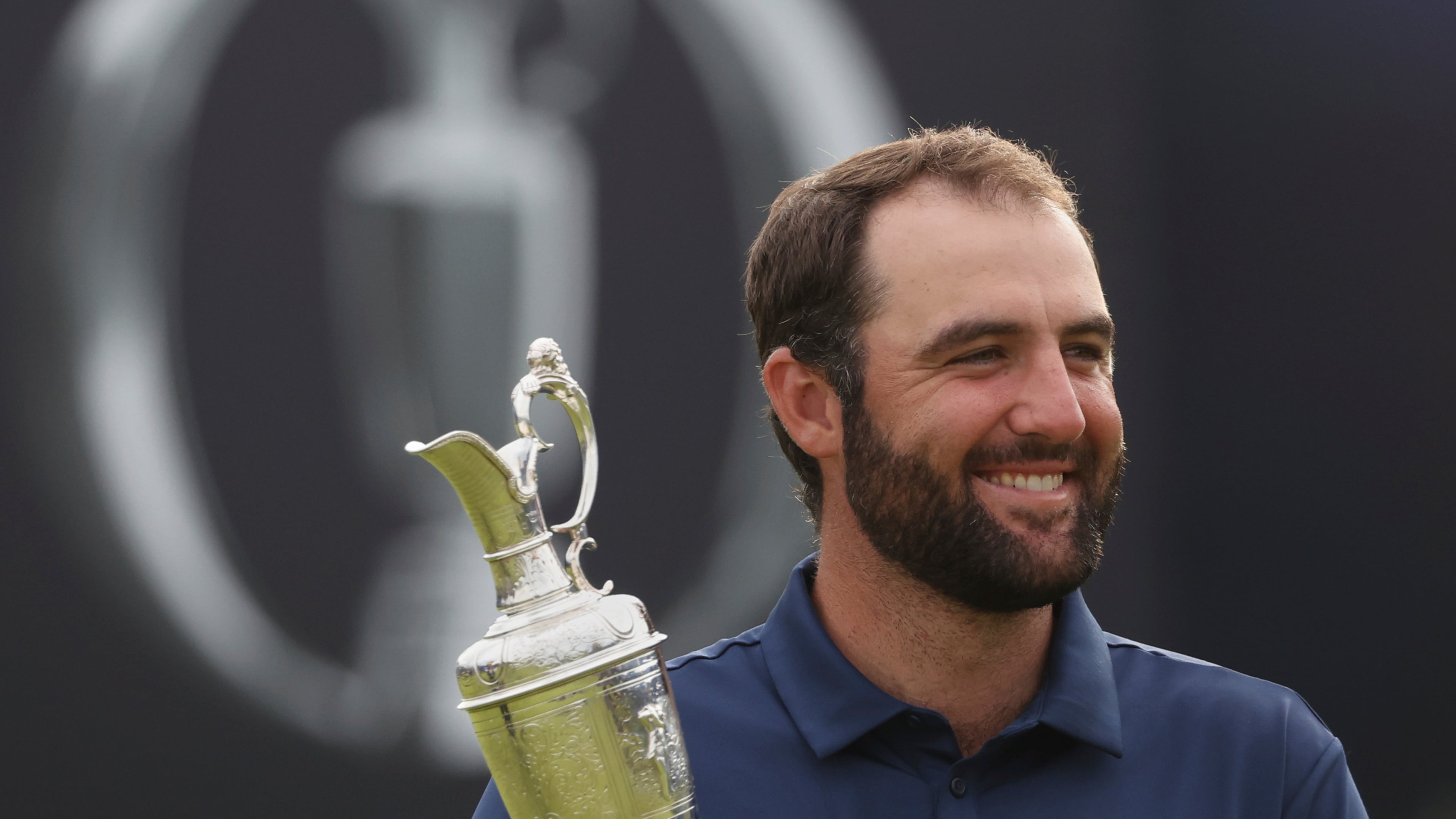 FILE - Scottie Scheffler of the United States holds the Claret Jug trophy as he poses for photographers after winning the British Open golf championship at the Royal Portrush Golf Club, Northern Ireland, July 20, 2025. (AP Photo/Peter Morrison, File)