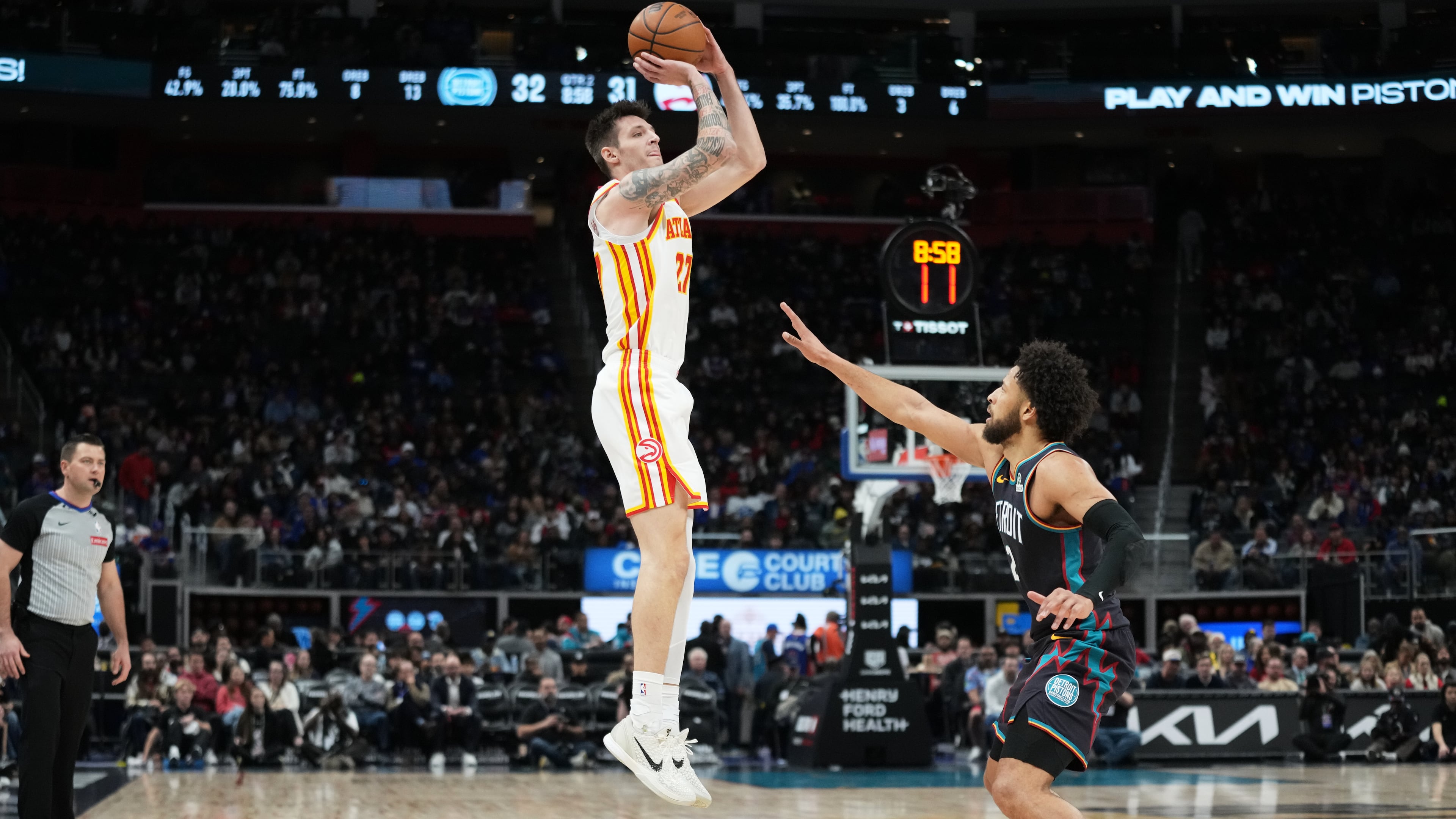 Atlanta Hawks guard Vit Krejci, left, shoots against Detroit Pistons guard Cade Cunningham during the first half of an NBA basketball game, Monday, Dec. 1, 2025, in Detroit. (AP Photo/Ryan Sun)