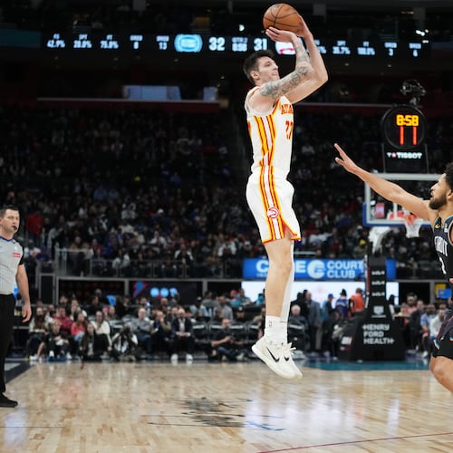 Atlanta Hawks guard Vit Krejci, left, shoots against Detroit Pistons guard Cade Cunningham during the first half of an NBA basketball game, Monday, Dec. 1, 2025, in Detroit. (AP Photo/Ryan Sun)