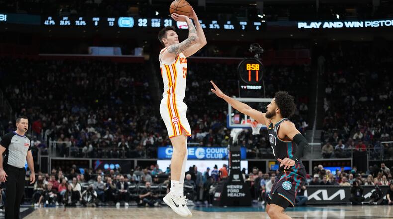 Atlanta Hawks guard Vit Krejci, left, shoots against Detroit Pistons guard Cade Cunningham during the first half of an NBA basketball game, Monday, Dec. 1, 2025, in Detroit. (AP Photo/Ryan Sun)