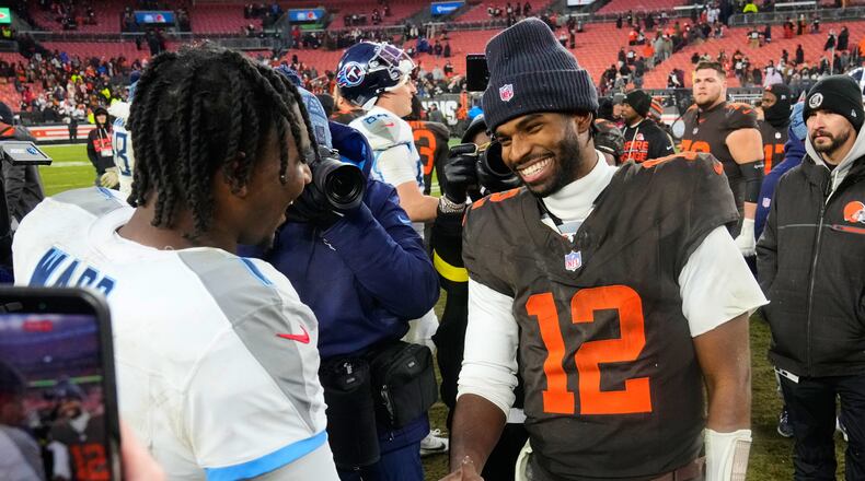Tennessee Titans quarterback Cam Ward, left, and Cleveland Browns quarterback Shedeur Sanders (12) greet each other after an NFL football game in Cleveland, Sunday, Dec. 7, 2025. (AP Photo/Sue Ogrocki)