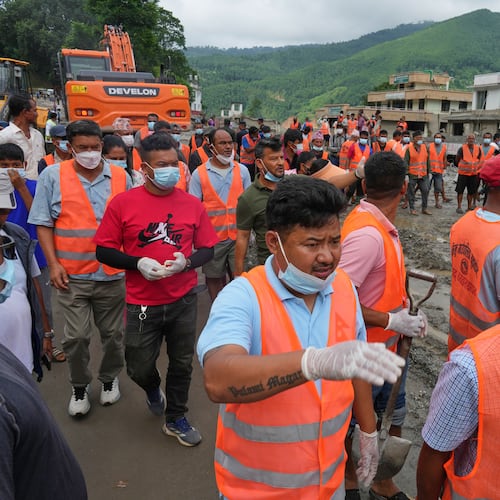 Rescuers arrive at a village affected by flash flooding in Nepal's Nuwakot district, Monday, Aug. 31, 2026. (AP Photo/Rajesh Kumar Singh)
