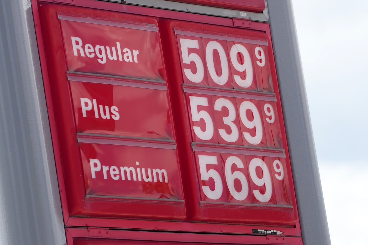 The per-gallon prices for the various grades of gasoline available at a gas station are displayed on a sign above the pumps, Sunday, May 24, 2026, in southeast Denver. (AP Photo/David Zalubowski)