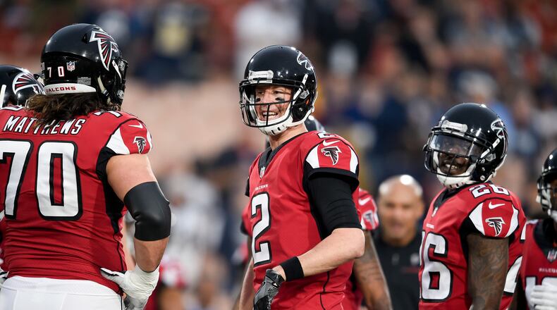 Atlanta Falcons quarterback Matt Ryan, center, warms up with tackle Jake Matthews, left, and running back Tevin Coleman before an NFL football wild-card playoff game against the Los Angeles Rams Saturday, Jan. 6, 2018, in Los Angeles. (AP Photo/Kelvin Kuo)