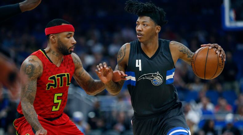 Atlanta Hawks guard Malcolm Delaney (5) guards against Orlando Magic guard Elfrid Payton (4) during the first quarter of an NBA basketball game in Orlando, Fla., on Saturday, Feb. 25, 2017. (AP Photo/Reinhold Matay)