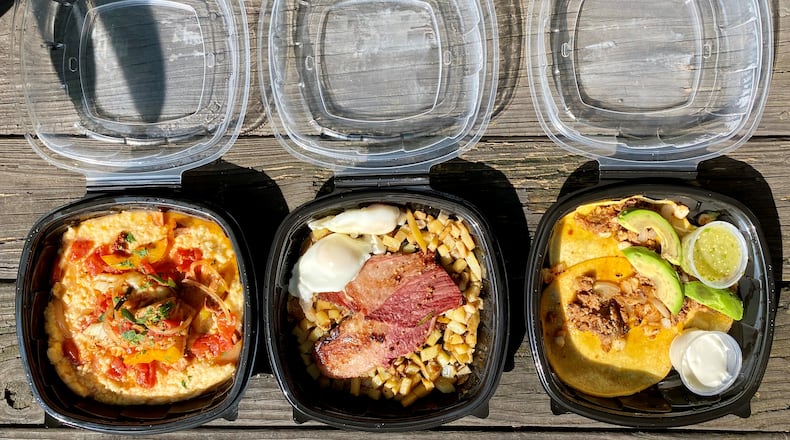This takeout order from Hot Betty’s in Tucker includes fish and grits, corned beef brisket hash with poached eggs, and breakfast tacos with chorizo, onion and hominy. Wendell Brock for The Atlanta Journal-Constitution
