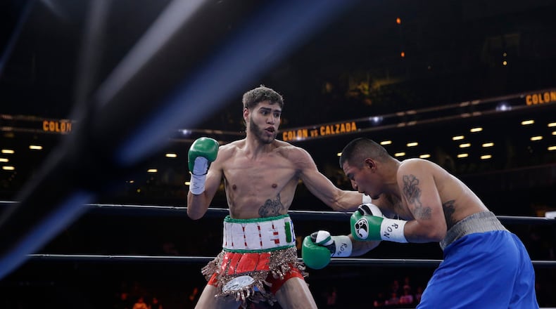 FILE - Prichard Colon, left, exchanges punches with Daniel Calzada during a junior middleweight title boxing match, Saturday, April 11, 2015, at New York. Colon won by TKO. (AP Photo/Mary Altaffer, file)