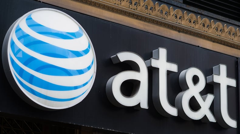 AT&T is cutting 1,800 jobs, a move that comes with contract talks about to begin in Atlanta with union leaders. (Bloomberg photo by Craig Warga)