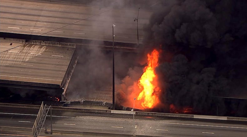 In this aerial image made from a video provided by WSB-TV, a large fire that caused an overpass on Interstate 85 to collapse burns in Atlanta, Thursday, March 30, 2017. Witnesses say troopers were telling cars to turn around on the bridge because they were concerned about its integrity. Minutes later, the bridge collapsed. (WSB-TV via AP)