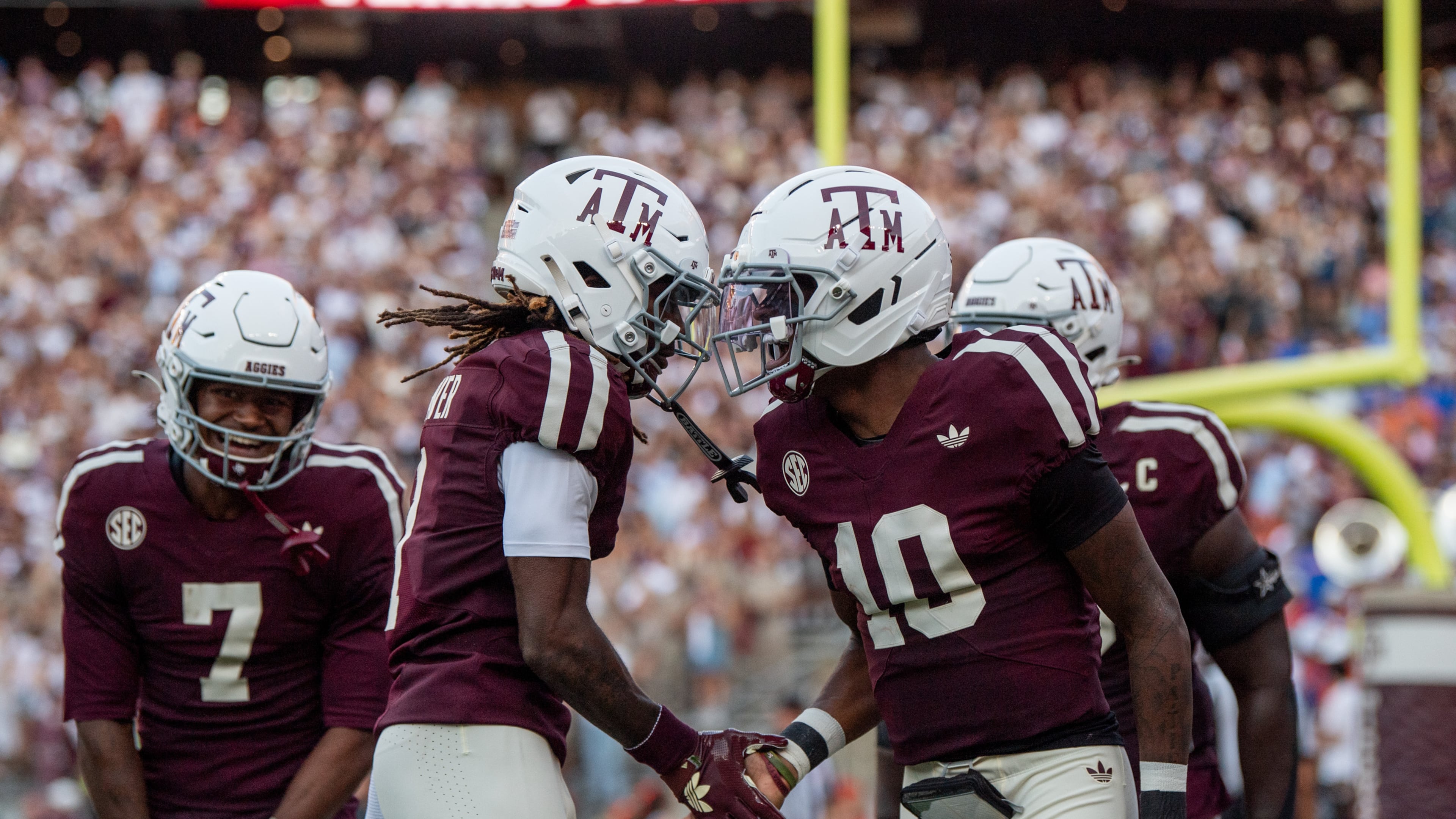 Texas A&M wide receiver KC Concepcion (7), Texas A&M wide receiver Mario Craver (1) and Texas A&M quarterback Marcel Reed (10) celebrate a touchdown against Florida during an NCAA college football game Saturday, Oct. 11, 2025, in College Station, Texas. (Meredith Seaver/College Station Eagle via AP)