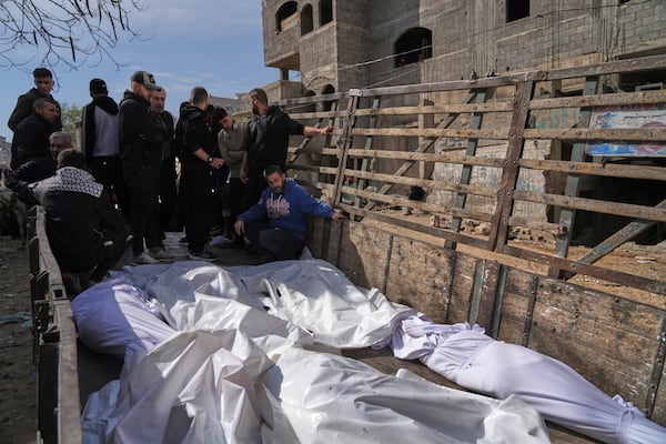 Palestinians accompany the bodies of their relatives killed in an Israeli airstrike, loaded onto a truck in preparation for burial, at Shifa Hospital in Gaza City, Wednesday, April 16, 2025. (AP Photo/Jehad Alshrafi)
