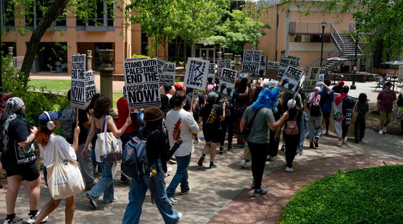 Kennesaw State University students gather and march across the campus. Students are demanding university divestment to Israel. Wednesday, May 1, 2024 (Ben Hendren for The Atlanta Journal-Constitution)