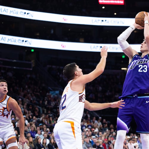 Utah Jazz forward Lauri Markkanen (23) shoots over Phoenix Suns guard Collin Gillespie (12) during the second half of an NBA basketball game, Monday, Oct. 27, 2025, in Salt Lake City. (AP Photo/Anna Fuder)