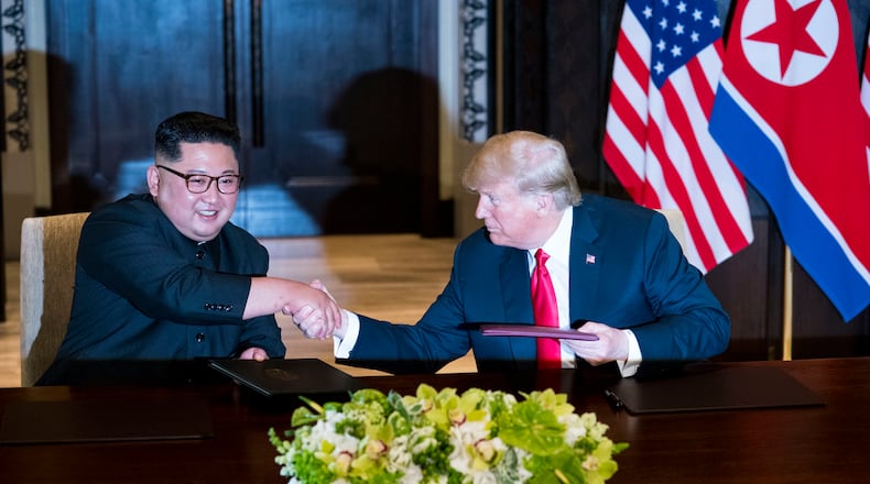 President Donald Trump and Kim Jong Un of North Korea during a document signing ceremony on Sentosa Island in Singapore, June 12, 2018. Since their meeting, a new propaganda film released in North Korea shows Kim as a global leader on an equal footing with Trump.