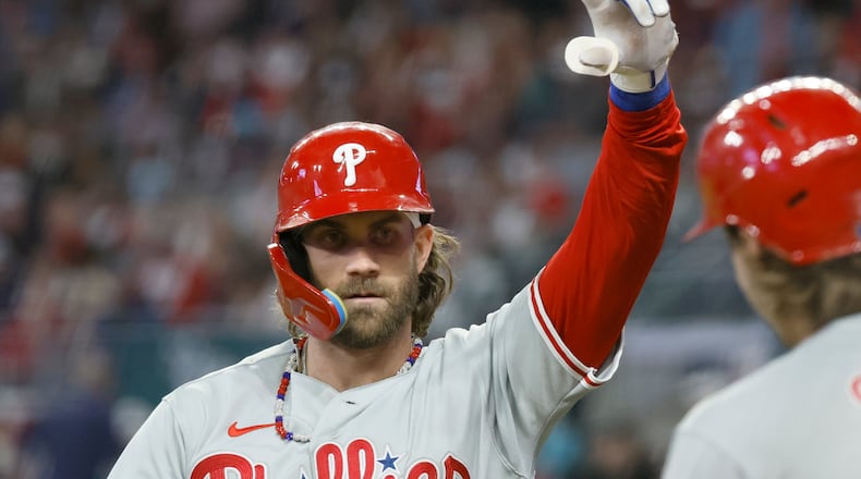 Philadelphia Phillies' Bryce Harper celebrates after hitting home run in sixth inning of Game 1 of the NLDS at Truist Park in Atlanta on Saturday, Oct. 7, 2023. (Miguel Martinez / Miguel.Martinezjimenez@ajc.com)