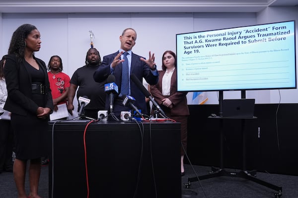 Jerome Block, partner, Levy & Konigsberg LLP, right, talks to media as attorney Kristen Feden, 1st left, listens to him during a news conference in Chicago, Wednesday, July 16, 2025. (AP Photo/Nam Y. Huh)