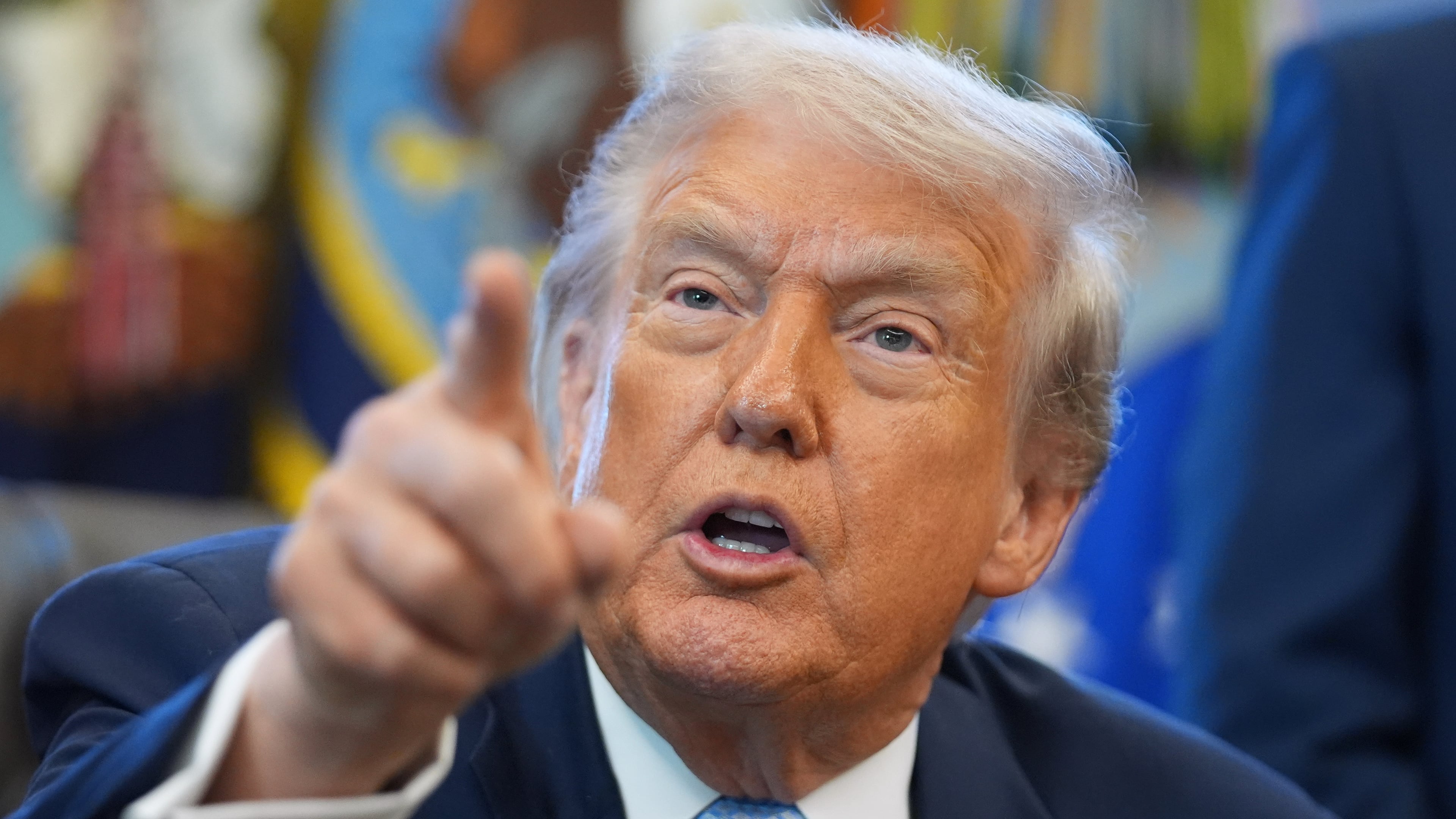 President Donald Trump answers questions from reporters during a meeting with the White House task force on the 2026 FIFA World Cup in the Oval Office of the White House, Monday, Nov. 17, 2025, in Washington. (AP Photo/Evan Vucci)